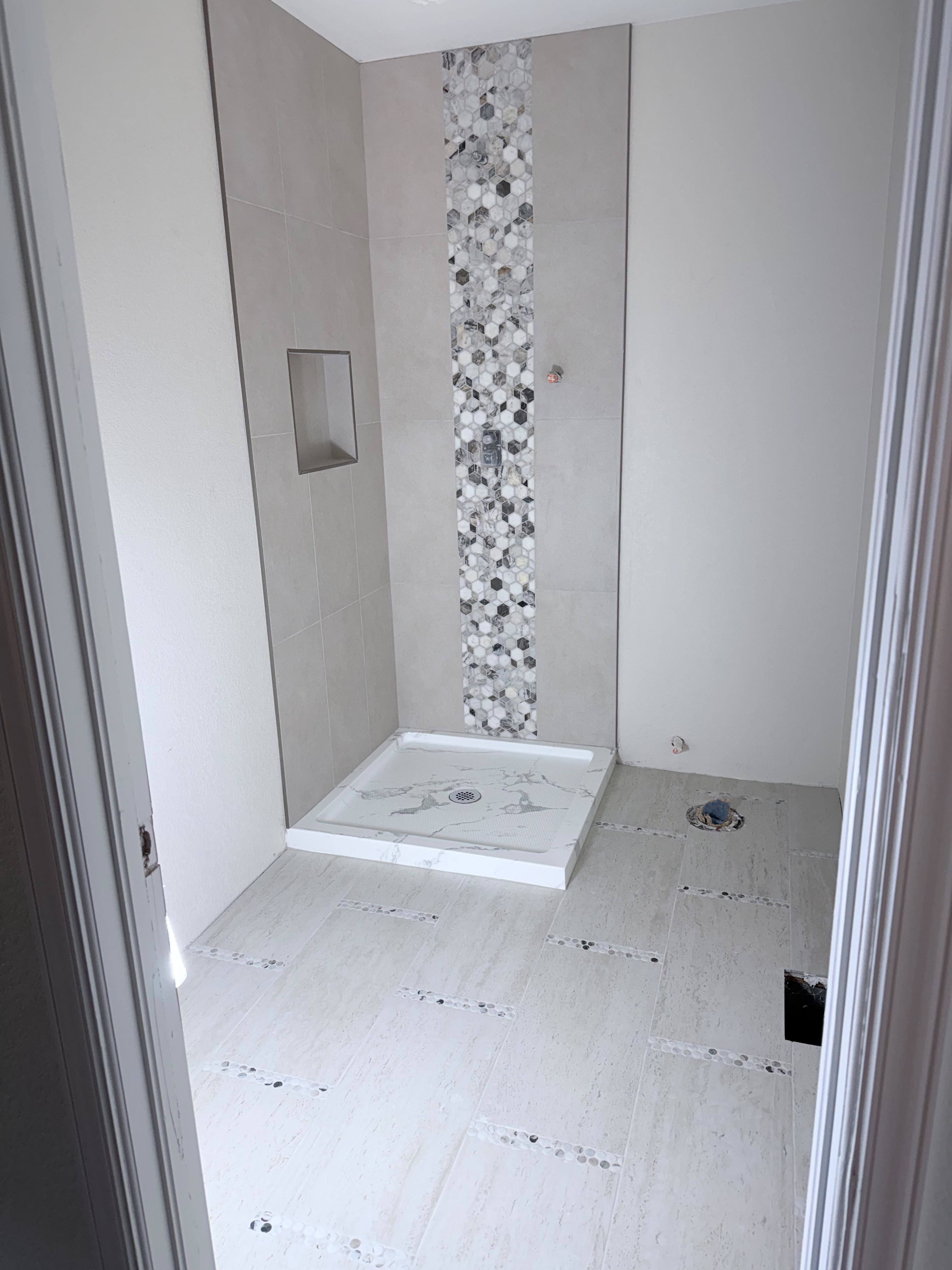 Bathroom remodel with marble hexagon mosaic shower by Romero's Tile & Stone