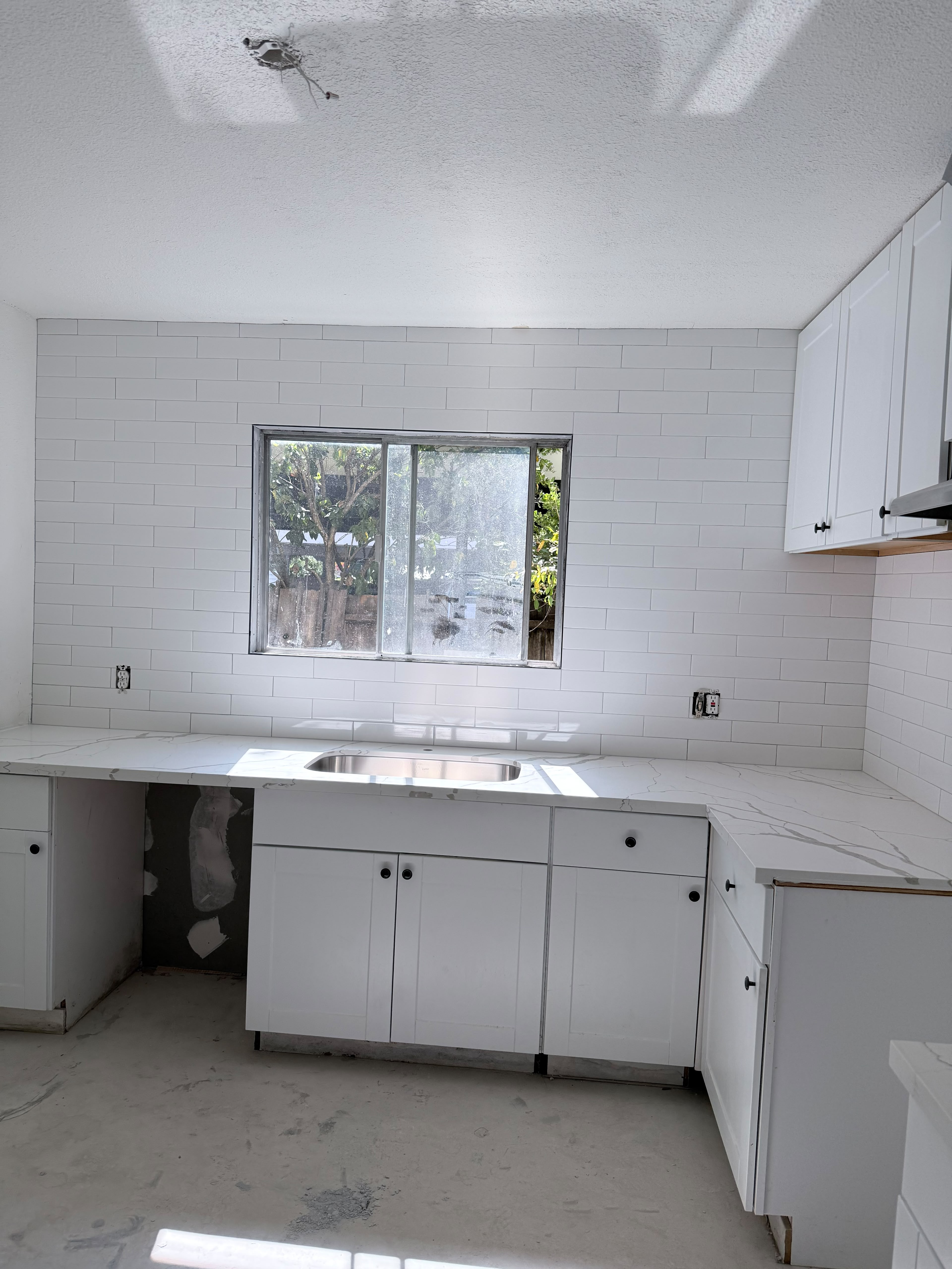 Finished kitchen backsplash and countertop tilework
